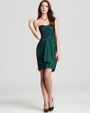 In a lustrous emerald hue, this strapless Aqua dress embodies the season's tendency toward jewel tones.