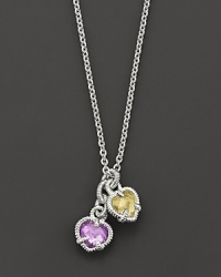 A twin heart necklace in canary crystal and amethyst quartz framed in sterling silver. Designed by Judith Ripka. A twin heart necklace in canary crystal and amethyst quartz framed in sterling silver. Designed by Judith Ripka.
