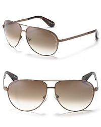 MARC BY MARC JACOBS classic and always in style aviator sunglasses with Marc Jacobs logo engraving on temple. Offered in brown with tortoise-inspired ear piece and brown gradient lens and black with dark burgundy ear piece and gray gradient lens. MARC BY MARC JACOBS classic and always in style aviator sunglasses with Marc Jacobs logo engraving on temple. Offered in brown with tortoise-inspired ear piece and brown gradient lens and black with dark burgundy ear piece and gray gradient lens.