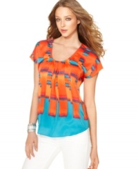 Jazz up denim with this colorful Calvin Klein Jeans top! The ikat-inspired print looks ultra-luxe paired with white or blue jeans. Jazz up denim with this colorful Calvin Klein Jeans top! The ikat-inspired print looks ultra-luxe paired with white or blue jeans.