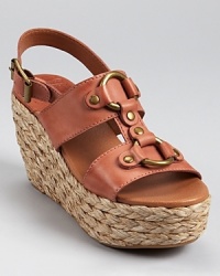 Aged hardware adds a vintage touch to Lucky Brand's Reba wedges, constructed in smooth leather and finished with a braided jute sole. Aged hardware adds a vintage touch to Lucky Brand's Reba wedges, constructed in smooth leather and finished with a braided jute sole.