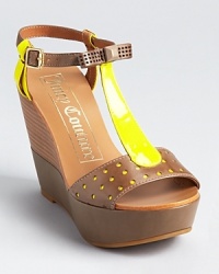Neon lemon leather is mixed with neutral stone on these Juicy Couture wedges, showcasing perforation and bow details. Neon lemon leather is mixed with neutral stone on these Juicy Couture wedges, showcasing perforation and bow details.