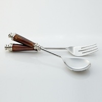 Earthy amber-colored enamel handles pop against polished stainless steel in these earthy salad servers from Simply Designz. Earthy amber-colored enamel handles pop against polished stainless steel in these earthy salad servers from Simply Designz.