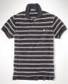 A classic-fitting short-sleeved polo shirt is crafted from breathable cotton mesh with a sleek striped pattern for casual polish.