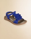 A sweet pair of cozy sandals is given a pretty update with tiers of ruffles.Grip-tape closureLeather upperLeather liningRubber solePadded insoleImported