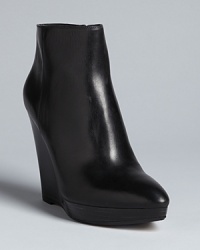 These KORS Michael Kors booties are right en point this season, with trend-right pointed toes on sleek platform wedges. These KORS Michael Kors booties are right en point this season, with trend-right pointed toes on sleek platform wedges.