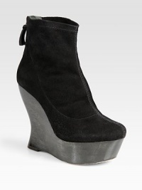 Lifted by a statuesque, architectural wooden wedge, this stretch suede ankle boot has an exposed back zipper and wooden platform. Wooden wedge, 5 (125mm)Wooden platform, 1½ (40mm)Compares to a 3½ heel (90mm)Stretch suede upperBack zipperLeather lining and solePadded insoleImportedOUR FIT MODEL RECOMMENDS ordering one size up as this style runs small. 