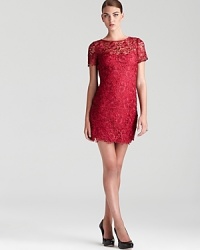 A simple sheath in floral lace boasts timeless style. From Aidan Mattox. A simple sheath in floral lace boasts timeless style. From Aidan Mattox.