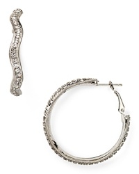 Delicately adorned with crystal stones, this pair of shapely hoop earrings from Aqua is a modern take on an ever-chic style. Slip them in as a modern touch. Delicately adorned with crystal stones, this pair of shapely hoop earrings from Aqua is a modern take on an ever-chic style. Slip them in as a modern touch.