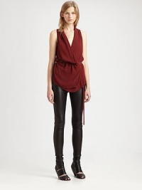 Lightweight fabric elegantly drapes on this crossover silhouette with a leather belt at the waist. Crossover v-neckSleeveless with frayed hemLeather self-tie belted waistAbout 29 from shoulder to hemBody: 75% viscose/25% virgin woolTrim: leatherDry cleanImported of Italian fabricModel shown is 5'10 (177cm) wearing US size Small. Lightweight fabric elegantly drapes on this crossover silhouette with a leather belt at the waist. Crossover v-neckSleeveless with frayed hemLeather self-tie belted waistAbout 29 from shoulder to hemBody: 75% viscose/25% virgin woolTrim: leatherDry cleanImported of Italian fabricModel shown is 5'10 (177cm) wearing US size Small.
