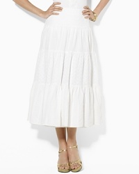 A breezy maxi skirt is rendered with tiers of embroidered cotton, each finished with a varying, delicate pattern. A breezy maxi skirt is rendered with tiers of embroidered cotton, each finished with a varying, delicate pattern.