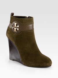 A gleaming signature emblem tops this suede and leather wedge design with contrast stitching. Stacked wedge, 4½ (115mm)Suede and leather upperSide zip and back leather pull-tabLeather liningRubber solePadded insoleImported A gleaming signature emblem tops this suede and leather wedge design with contrast stitching. Stacked wedge, 4½ (115mm)Suede and leather upperSide zip and back leather pull-tabLeather liningRubber solePadded insoleImported