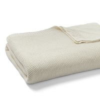 A chunky, soft knit blanket in a neutral hue from DIANE von FURSTENBERG elevates a simple bedding ensemble. A chunky, soft knit blanket in a neutral hue from DIANE von FURSTENBERG elevates a simple bedding ensemble.