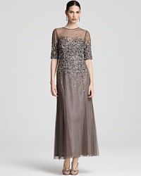 Sprinkled with sparkling sequins, this Adrianna Papell gown boasts a sheer yoke and floor-sweeping chiffon skirt. Sprinkled with sparkling sequins, this Adrianna Papell gown boasts a sheer yoke and floor-sweeping chiffon skirt.