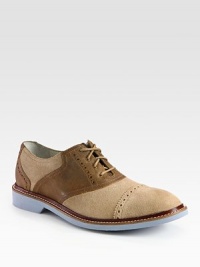 Signature saddle shoe design in leather and suede with a refined, perforated detail.Suede/leather upperLeather liningPadded insoleFoam soleImported Signature saddle shoe design in leather and suede with a refined, perforated detail.Suede/leather upperLeather liningPadded insoleFoam soleImported