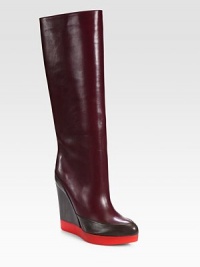 Commanding design of supple leather in rich seasonal hues, resting on a comfortable platform wedge. Rubber and leather-covered heel, 4½ (115mm)Rubber platform, 1 (25mm)Shaft, 14½Leg circumference, 14Leather upperPull-on styleLeather liningRubber solePadded insoleMade in Italy Commanding design of supple leather in rich seasonal hues, resting on a comfortable platform wedge. Rubber and leather-covered heel, 4½ (115mm)Rubber platform, 1 (25mm)Shaft, 14½Leg circumference, 14Leather upperPull-on styleLeather liningRubber solePadded insoleMade in Italy