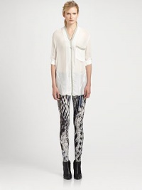 Starkly chic shirt in a semi-sheer silhouette with contrast trim and menswear-inspired details. V-neckDropped shouldersLong sleeves with buttoned cuffsHidden button frontSingle front patch pocketLonger length hits below the hipsViscoseDry cleanMade in USA of Italian fabricModel shown is 5'11 (178cm) wearing US size Small. Starkly chic shirt in a semi-sheer silhouette with contrast trim and menswear-inspired details. V-neckDropped shouldersLong sleeves with buttoned cuffsHidden button frontSingle front patch pocketLonger length hits below the hipsViscoseDry cleanMade in USA of Italian fabricModel shown is 5'11 (178cm) wearing US size Small.