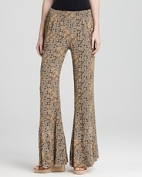 A hint of hippie style shows through with these Free People pants, boasting a global print and wide leg silhouette for easy weekend style. A hint of hippie style shows through with these Free People pants, boasting a global print and wide leg silhouette for easy weekend style.