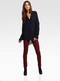 Delicate silk v-neck with long dolman sleeves and a hidden button front. V-neckHidden button frontLong dolman sleevesHi-low hemSilkDry cleanImportedModel shown is 5'11 (180cm) wearing US size Small.