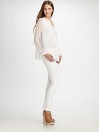 Semi-sheer silk v-neck with a hidden button front and long silhouette that hits below the hips. V-neckLong sleevesButtoned cuffsHidden button frontLonger length hits below the hipsSilkDry cleanImportedModel shown is 5'11 (180cm) wearing US size Small. Semi-sheer silk v-neck with a hidden button front and long silhouette that hits below the hips. V-neckLong sleevesButtoned cuffsHidden button frontLonger length hits below the hipsSilkDry cleanImportedModel shown is 5'11 (180cm) wearing US size Small.