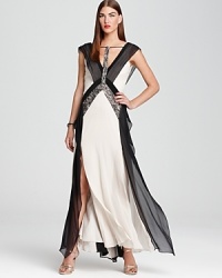 This BCBGMAXAZRIA gown feels decidedly modern in a color blocked silhouette and cool grey palette, dressed up with lace detailing. This BCBGMAXAZRIA gown feels decidedly modern in a color blocked silhouette and cool grey palette, dressed up with lace detailing.