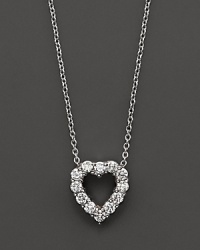 From the Tiny Treasures collection, a diamond heart necklace with signature ruby accent. Designed by Roberto Coin.