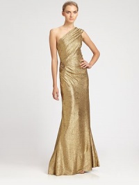 This elegant metallic design features a modern, asymmetrical neckline and a beaded detail at the hip.Asymmetrical necklineRiched bodiceBeaded side detailConcealed back zipFully linedAbout 46 from natural waistPolyesterDry cleanMade in USA of imported fabricModel shown is 5'10 (177cm) wearing US size 4.This style runs large. We recommend ordering one size down for a standard fit. This elegant metallic design features a modern, asymmetrical neckline and a beaded detail at the hip.Asymmetrical necklineRiched bodiceBeaded side detailConcealed back zipFully linedAbout 46 from natural waistPolyesterDry cleanMade in USA of imported fabricModel shown is 5'10 (177cm) wearing US size 4.This style runs large. We recommend ordering one size down for a standard fit.