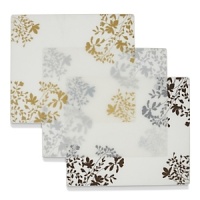A floral branch motif in metallic colors accent the edges of this translucent placemat. A floral branch motif in metallic colors accent the edges of this translucent placemat.