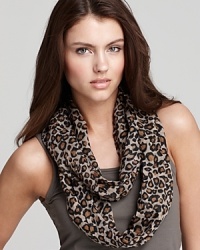 A lightweight loop scarf in a dark tan animal print, a fierce style from Fraas.