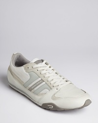 A melange of synthetic leather and suede sets apart this striking sporty design from Diesel, a versatile sneaker that complements a variety of shorts, jeans and pants. A melange of synthetic leather and suede sets apart this striking sporty design from Diesel, a versatile sneaker that complements a variety of shorts, jeans and pants.