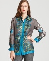 Brimming with Eastern inspiration, a silk BASLER blouse blooms with a bold floral print for a truly stunning style.
