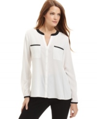 Contrasting trim gives this chic Calvin Klein blouse a bold boost.