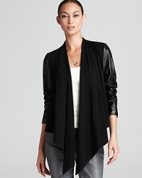 The ultimate in city-chic sophistication, this Bagatelle jacket flaunts sleek leather sleeves and an edgy asymmetrical front for untamed urban attitude. The ultimate in city-chic sophistication, this Bagatelle jacket flaunts sleek leather sleeves and an edgy asymmetrical front for untamed urban attitude.