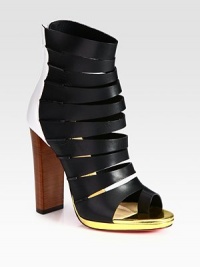 Propped up by a stacked heel, this leather cage design has a toe ring, back zipper and lustrous metallic leather trim. Stacked heel, 4 (100mm)Leather upperBack zipperLeather liningSignature red leather solePadded insoleMade in Italy Propped up by a stacked heel, this leather cage design has a toe ring, back zipper and lustrous metallic leather trim. Stacked heel, 4 (100mm)Leather upperBack zipperLeather liningSignature red leather solePadded insoleMade in Italy
