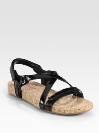 Patent leather style with two adjustable grip tape closures and a cork footbed. Patent leather upperCork liningRubber solePadded insoleImported Patent leather style with two adjustable grip tape closures and a cork footbed. Patent leather upperCork liningRubber solePadded insoleImported