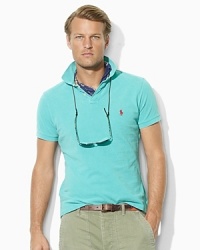 A short-sleeved polo shirt is cut for a roomy, relaxed fit in breathable cotton mesh that's specially washed for the weathered look and feel of a timeworn favorite. A short-sleeved polo shirt is cut for a roomy, relaxed fit in breathable cotton mesh that's specially washed for the weathered look and feel of a timeworn favorite.