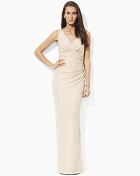 An exquisite design of metallic brocade creates a beautiful rippling effect on this evening dress, tailored in a floor-skimming silhouette with a dramatic slit for sexy sophistication. An exquisite design of metallic brocade creates a beautiful rippling effect on this evening dress, tailored in a floor-skimming silhouette with a dramatic slit for sexy sophistication.