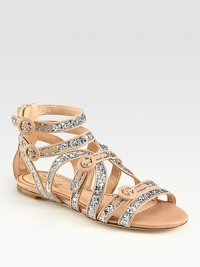 Glimmering glitter adds starlet vibes to this classic leather gladiator with adjustable straps and an exposed back zipper. Glitter-coated leather upperBack zipperLeather lining and solePadded insoleMade in Italy Glimmering glitter adds starlet vibes to this classic leather gladiator with adjustable straps and an exposed back zipper. Glitter-coated leather upperBack zipperLeather lining and solePadded insoleMade in Italy