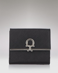 A luxe trifold wallet in textured leather with signature lock detail from Salvatore Ferragamo. A luxe trifold wallet in textured leather with signature lock detail from Salvatore Ferragamo.