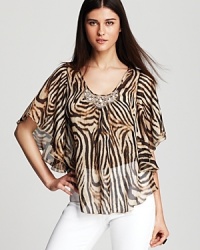 A vibrant swirl of tiger stripes enlivens this sheer Karen Kane top, finished with a beaded neckline for a glamorous walk on the wild side. A vibrant swirl of tiger stripes enlivens this sheer Karen Kane top, finished with a beaded neckline for a glamorous walk on the wild side.