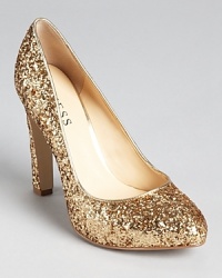 Dipped in glitter, these sparkling GUESS pumps lend lighthearted glamour for the girl that likes to have fun with fashion. Dipped in glitter, these sparkling GUESS pumps lend lighthearted glamour for the girl that likes to have fun with fashion.