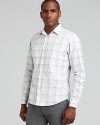 A light plaid print brings subtle texture to this sleek, slim fit button down from Theory.