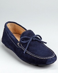 Treat your feet to this luxe suede loafer, finished with a stitched moc toe and tie detail at the tongue. Treat your feet to this luxe suede loafer, finished with a stitched moc toe and tie detail at the tongue.