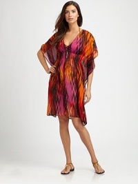 A plunging v-neck with an elastic Empire waist set the stage for this flattering coverup. V-neckDolman sleevesFront button detailsElasticized waistlineSilkHand washImported A plunging v-neck with an elastic Empire waist set the stage for this flattering coverup. V-neckDolman sleevesFront button detailsElasticized waistlineSilkHand washImported