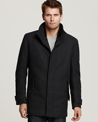 Urbane cool is effortlessly achieved with a streamlined thigh-length wool jacket featuring a stand up collar from Andrew Marc. Urbane cool is effortlessly achieved with a streamlined thigh-length wool jacket featuring a stand up collar from Andrew Marc.