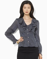A flourish of ruffles and a peplum hem add feminine allure to a soft woven cotton blouse, finished in a heritage checked pattern. A flourish of ruffles and a peplum hem add feminine allure to a soft woven cotton blouse, finished in a heritage checked pattern.