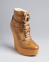 Take the ultimate approach to the athletic-inspired wedge bootie in this simply smashing Burberry design. Take the ultimate approach to the athletic-inspired wedge bootie in this simply smashing Burberry design.