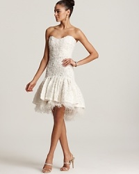 Fashioned in exquisite lace, this Badgley Mischka strapless dress flaunts a flouncy skirt with a peek-a-boo hem of plush plumes. Fashioned in exquisite lace, this Badgley Mischka strapless dress flaunts a flouncy skirt with a peek-a-boo hem of plush plumes.