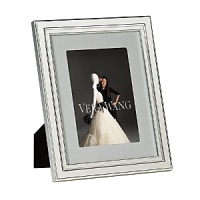The Vera Wang Chime silver-plated frame collection pulls inspiration from the popular Vera Wang flatware pattern. The frames include a pale gray grosgrain ribbon fabric mat, adding elegance and refinement to any photograph. The Vera Wang Chime silver-plated frame collection pulls inspiration from the popular Vera Wang flatware pattern. The frames include a pale gray grosgrain ribbon fabric mat, adding elegance and refinement to any photograph.