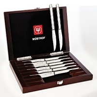 These Wüsthof high-carbon, precision forged, 18/10 stainless steel steak knives feature a serrated cutting edge and polished handles. Includes wood presentation box with rosewood stain. These Wüsthof high-carbon, precision forged, 18/10 stainless steel steak knives feature a serrated cutting edge and polished handles. Includes wood presentation box with rosewood stain.